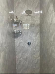 a shower with a glass door in a bathroom at Tia Maria cottage in Cape Town