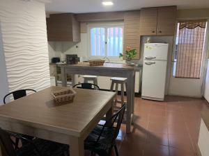 cocina con mesa y nevera blanca en Apartamento amoblado excelente ubicación en San Rafael