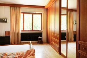 a bedroom with a bed and a large window at Jagdreich im Westerwald 