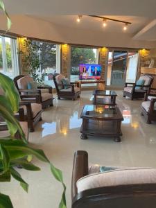 a lobby with couches and a flat screen tv at Altair Hotel in San Clemente del Tuyú