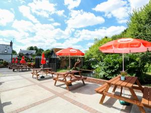 a group of picnic tables with umbrellas on a patio at West View in Newport