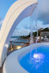 a swimming pool with a water fountain at SuRFCoRe House in Baía Formosa