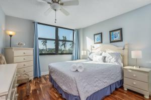 a bedroom with a bed with two slippers on it at Harbor Tower Intracoastal Condo in Siesta Key +42 photos