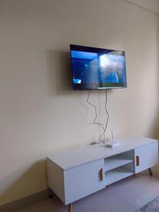 a living room with a tv on a wall at Smarts residence in Nairobi