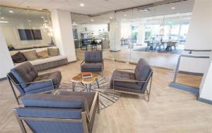 a lobby with chairs and a table in a building at Charming Hollywood Condo with Pool & Balcony in Los Angeles