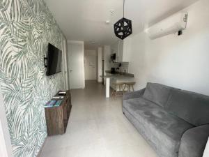 a living room with a couch and a tv at 2br aptSurrounded by history with Modern Amenities in Panama City