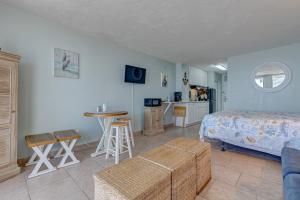 a bedroom with a bed and a table and a kitchen at The Ocean Calls, Unit #612 in Daytona Beach