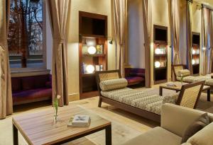 a living room with a couch and a table at NH Collection Palacio de Burgos in Burgos