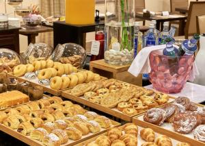 a display of different types of donuts and other pastries at NH Collection Palacio de Burgos in Burgos