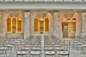 an empty hall with rows of chairs in a building at NH Collection Palacio de Burgos in Burgos