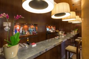 a bar in a hotel room with a long counter at NH Collection Palacio de Burgos in Burgos