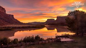 a view of a river at sunset in a canyon at Red Cliffs Lodge in Moab