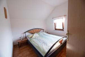a bedroom with a bed and a table and a window at Holiday home in Metlika Kranjska Krain 26051 in Metlika