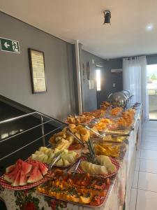 a buffet line with many different types of food at Hotel Rota do Sertão in Serra Talhada