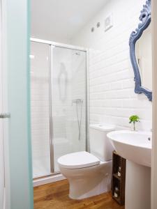 a bathroom with a shower and a toilet and a sink at República Guest House in Coimbra