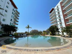 a large swimming pool in the middle of two buildings at 3010 Habitación en Pacifika, excelente ubicación in Mazatlán