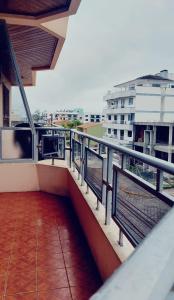 a balcony with a view of a building at Apto com Varanda 104 - Balneário Arroio do Silva - 300 metros do Mar in Arroio do Silva