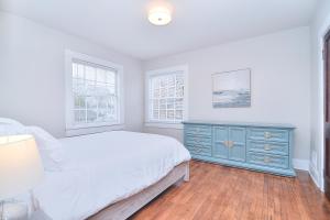 a bedroom with a bed and a blue dresser at Historic McSwain House in Shelby