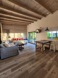a living room with a couch and a table at La Pelereca in Las Gaviotas