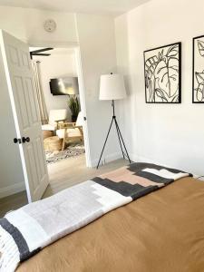 a bedroom with a bed and a living room at Coastal inspired apartment in downtown culver city in Los Angeles
