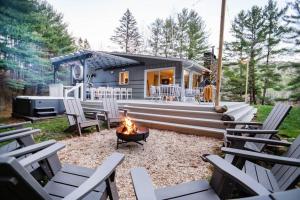 a fire pit in front of a tiny house at Catskill MNTN Escape 5 BR 3 bath Villa Hot Tub Fire Pit Best Group Stay in Prattsville