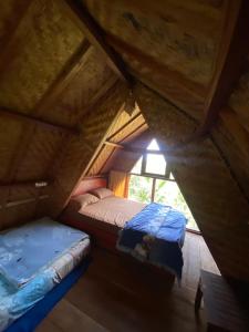 a small room with a bed and a window at Tetebatu Sama Sama Bungalows in Tetebatu