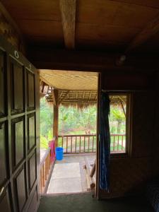 an open door of a house with a porch at Tetebatu Sama Sama Bungalows in Tetebatu