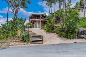a house with stairs leading up to a house at Seascape Paradise in Airlie Beach
