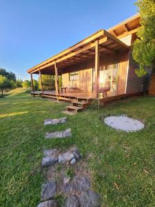 a large house with a roof on a grass field at La Pelereca in Las Gaviotas