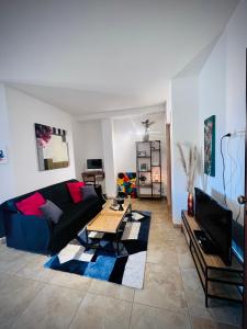 a living room with a couch and a table at WEST SARDINIA APARTMENT 3 in Càbras