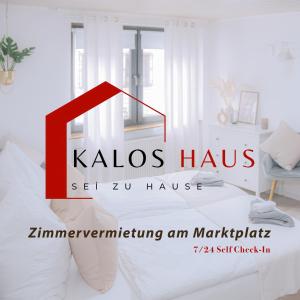 a room with a bed with the kalo haus logo at Haus Kalos in Haiger