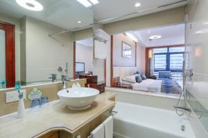 a bathroom with a sink and a large mirror at Yiwu Ocean Hotel - Original Best Western Premier Ocean Hotel in Yiwu