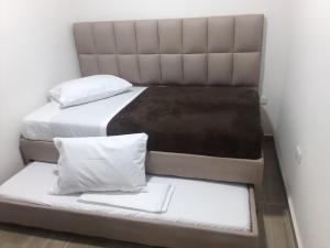 two beds in a small room with two mattresses at Apartamentos LM in Santa Rosa de Cabal