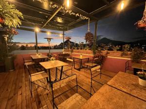 a restaurant with tables and chairs on a deck at Casa Flora Handmade Hotel in Atlixco