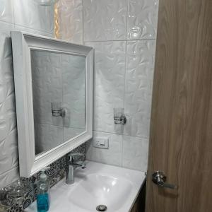 a bathroom with a sink and a mirror at SWEET BREEZE in San Andrés