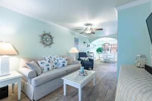 a living room with a couch and a table at Gorgeous Coastal Condo Barefoot Beach Indian Shore in Clearwater Beach