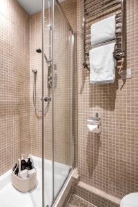 a bathroom with a shower and a toilet at Covent Garden gem apartment in London
