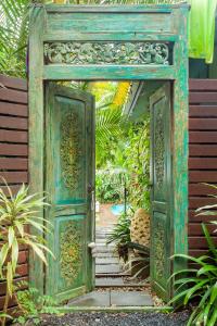 an open door in a garden with plants at Sanctuary in The Pocket in The Pocket