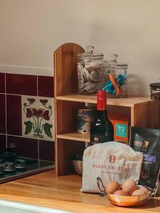 a kitchen counter with a bottle of wine and eggs at Sanctuary in The Pocket in The Pocket