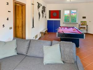a living room with a couch and a pool table at PrimeStay in Nicolosi