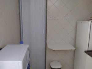 ein kleines Bad mit einem Kühlschrank und einem WC in der Unterkunft CopApê in Rio de Janeiro
