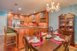 a kitchen with a wooden table and chairs and a dining room at St. George Street Apartment in St. Augustine