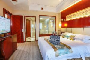 a hotel room with a large bed and a flat screen tv at Yiwu Ocean Hotel - Original Best Western Premier Ocean Hotel in Yiwu