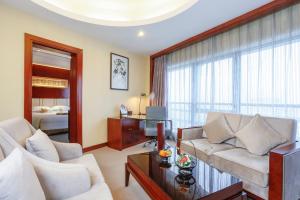 a living room with a couch and a table at Yiwu Ocean Hotel - Original Best Western Premier Ocean Hotel in Yiwu