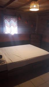 a large bed in a room with a light at Yatzil in La Trinitaria