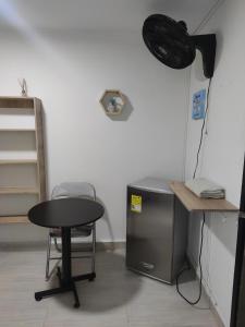 a room with a desk and a table and a chair at HABITACION AMOBLADA SECTOR LAURELES-ESTADIO #1 Madrid in Medellín