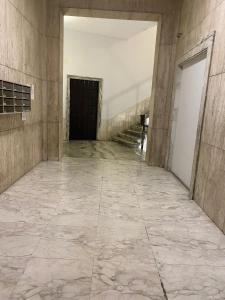 an empty hallway of a building with a door at Due Passi dal Porto in Genoa