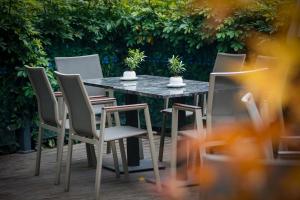 a table and chairs with potted plants on it at Yiwu Ocean Hotel - Original Best Western Premier Ocean Hotel in Yiwu