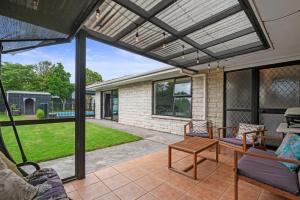 a patio with awning and a table and chairs at Little Big House - Rotorua Holiday Home in Rotorua