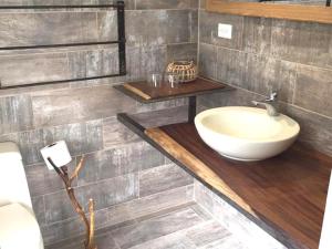 a bathroom with a sink on a wooden counter at Cote Pacific Casitas in Huacas